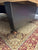 Dark metal object on a patterned rug