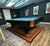 Pool table in a room with movie posters on the walls