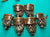 Six vintage brass or bronze lanterns with diamond-patterned metal mesh bodies and dark brown leather-like bands, arranged on a bright turquoise background.