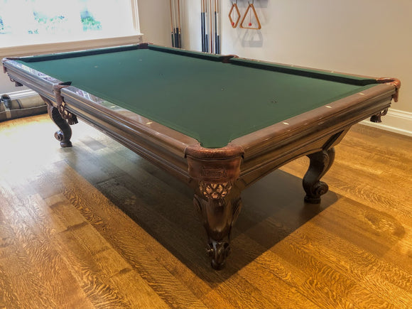 9' PREOWNED CANADA BILLIARD SOLID WOOD SLATE POOL TABLE INSTALLED WITH ACCESSORIES. WALNUT FINISH