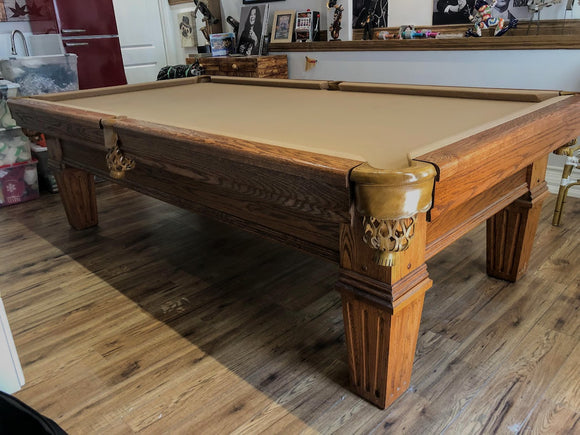 9' PREOWNED CUSTOM MADE SOLID OAK SLATE POOL TABLE INSTALLED WITH ACCESSORIES.
