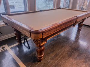 9' PREOWNED CANADA BILLIARD SOLID OAK SLATE POOL TABLE INSTALLED WITH ACCESSORIES. CHERRY FINISH
