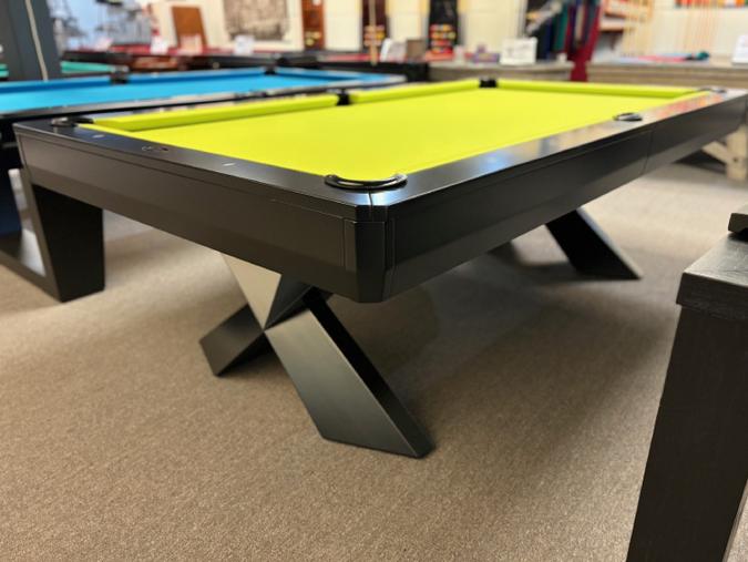 Pool table with green felt surface in a room setting