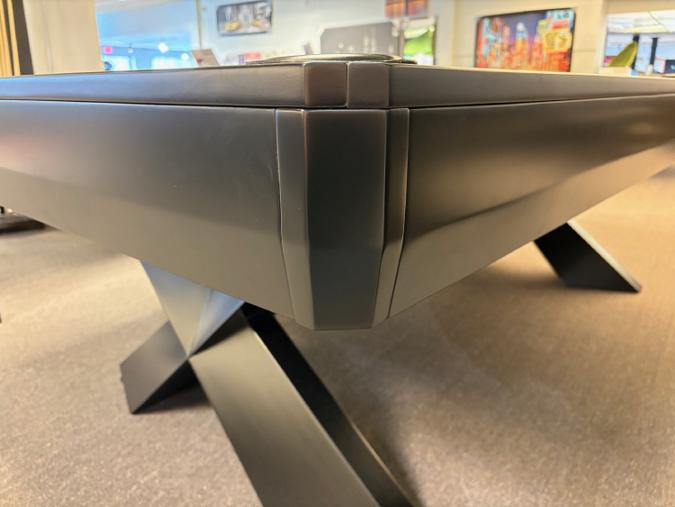 Close-up of a modern dining table with a blurred indoor background