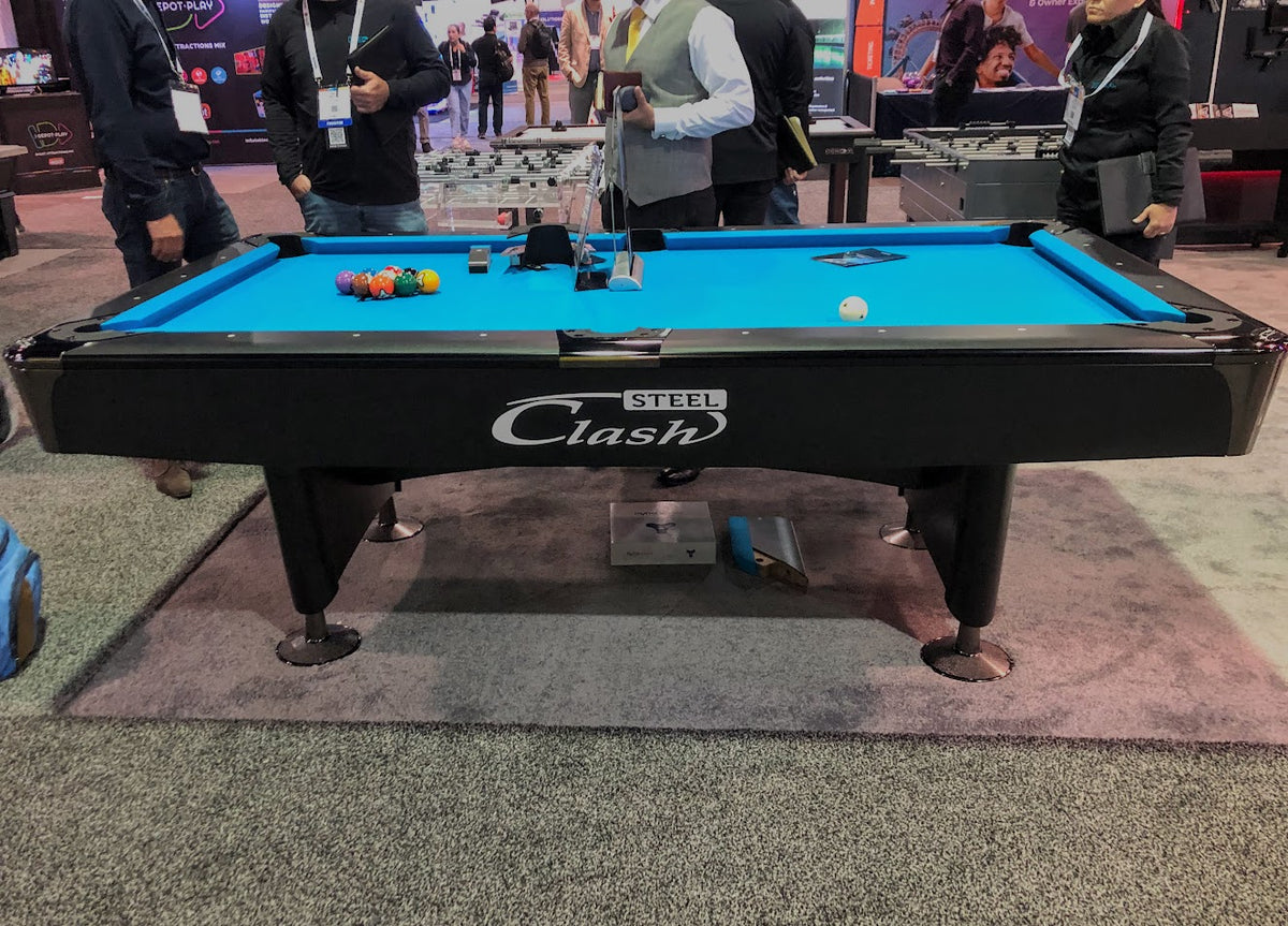 Black base Clash Steele billiard table on the carpet 