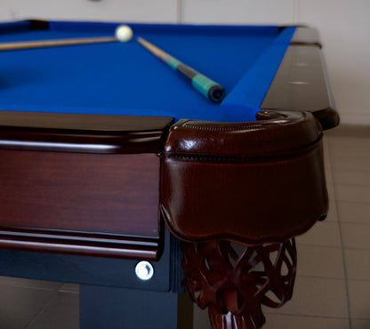 The corner of Majestic Orleans 7-foot pool table with leather drop pocket and billiard cues