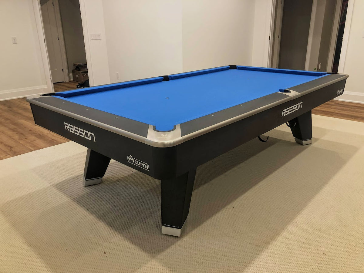 Angle View of Rasson Acurra 9-foot black pool table with leather drop pockets and slate playing surface
