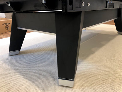 Square legs view of Rasson Acurra 9-foot black pool table with with metal bottom of legs