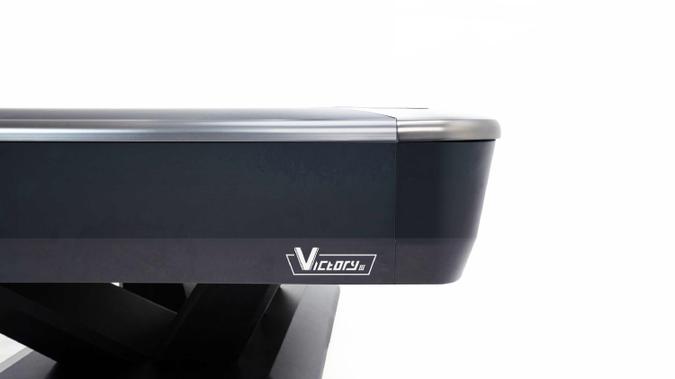 Close-up of a pool table with 'Victory' branding on a white background