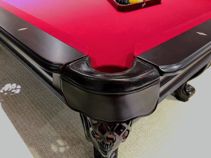 A  mahogany wood pool table  leather-fringed pocket.